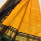 Close view of the deep black Kai Korvai border with gold Kamalam medallions, Malli Moggu ornament and emerald-green edge.