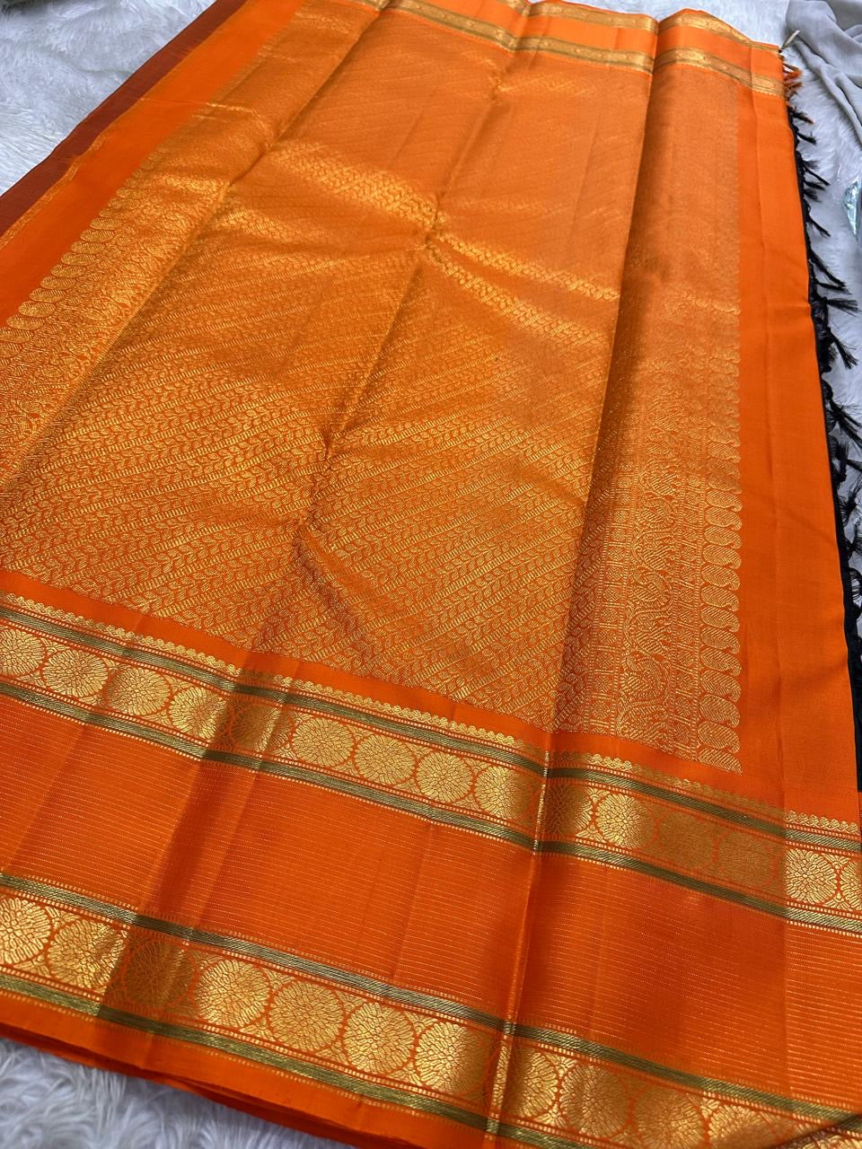 Nirupama ✨ – Bottle-Green Kanchipuram Pure Silk Saree
With Striking Saffron-Orange Korvai Contrast Border rettapet 
Adorned with Gold Rosette Buttas & Medallion Bands
Grand Zari Brocade Pallu in Cascading Motifs