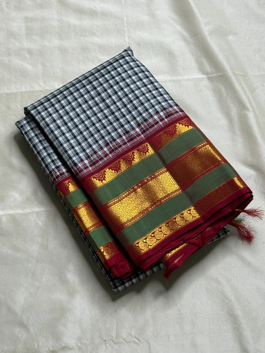 Onyx Plaid – Pure Kanchipuram Silk Saree
Black & Ivory Micro-Checks Body (Kattam) ✨
Parrot-Green Korvai Border with Gold Zari
Crimson Pallu with Orange Panel & Kaddi Stripes

Silk Mark Certified, delivery in 2 weeks