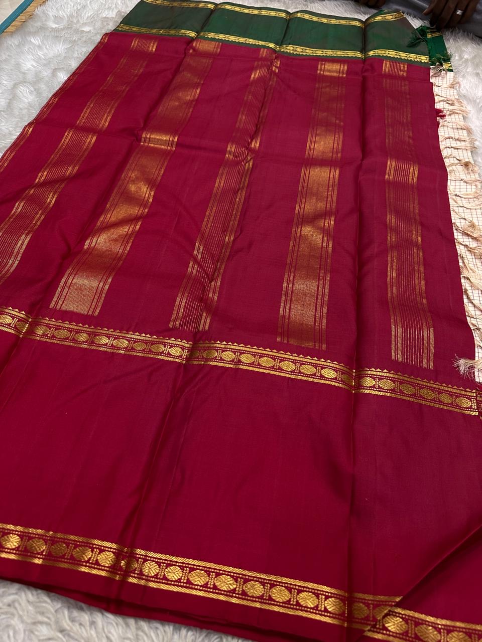 Full length display of maroon pallu and ivory kattam body with border highlights