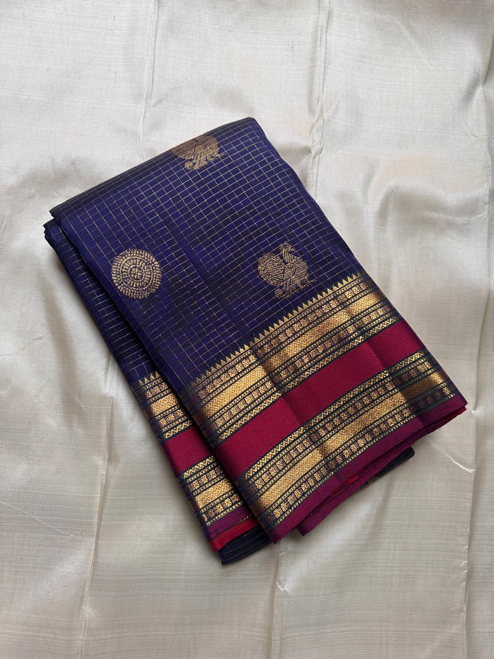Peacock Constellation Kattam
Midnight Navy Kanchipuram Silk Saree
Gold Zari Grid with Mandala & Peacock Buttas