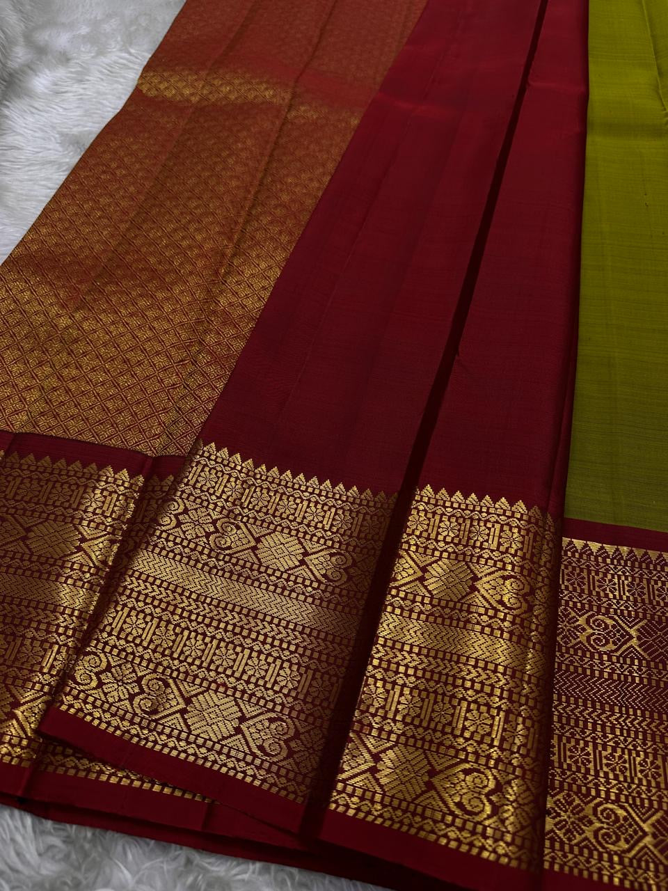 Golden Emerald Gleam ✨ – Pure Kanchipuram Silk Saree
Parrot Green & Turmeric Shot with Gold & Silver Leaf Buttas 🌿
Crimson Red Korvai Border with Temple Peaks  ❤️
Grand Crimson Pallu 🌟

Silk Mark Certified, delivery in 2 weeks