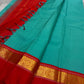Rama green handloom Kanchipuram silk saree fully spread out, featuring rich red kaal erangina pallu and traditional gold zari motifs.
