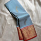 A saree where sky blue melts into sunrise orange—pure silk Kanchipuram magic.