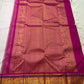 Fuchsia pallu spread out with dense gold zari weave and framed motif panels, with tassels visible at one end.
