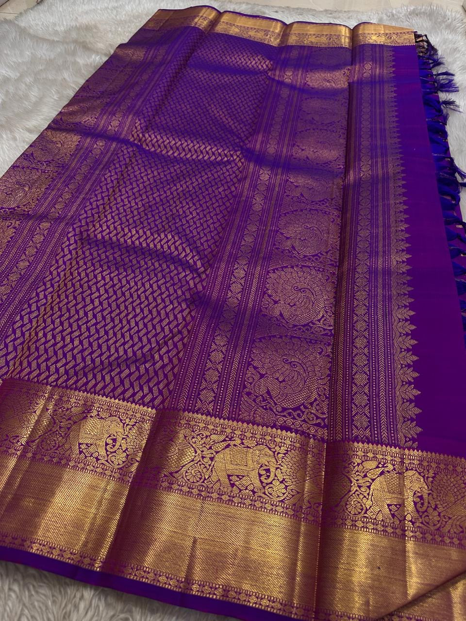 Amethyst Gandaberunda Kamalam – Pure Kanchipuram Silk Saree

Amethyst Purple Body with Zari Kattam Checks & Lotus Buttas

Grand Antique-Gold Borders with Gandaberunda & Peacock Motifs

Purple Zari Brocade Pallu

Silk Mark , ships in 2 weeks