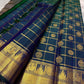 A celestial blend of blue and green, this Kanjivaram silk saree ,adorned with Gandaberunda and Kamalam buttas, golden checks, and a majestic thazhampoo Mayil  border. Zari kattam