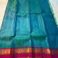 Kavi ✨ – Pure Kanchipuram Silk Saree
Teal Blue Silk Body with Lustrous Shot Weave
Rich Magenta Contrast Border in Gold Zari
Grand Pallu with Intricate Kili (Parrot) Motifs
Magenta Blouse with Matching Zari Border Silk Mark Certified, delivery in 2 weeks