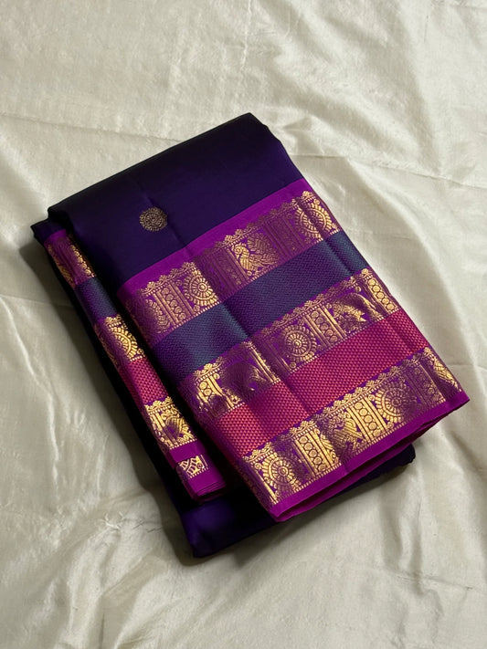 Peacock Purple Rajam – Pure Silk Kanchipuram Saree
Deep Peacock Purple Body with Gold Zari Buttas
Korvai Borders with Temple, Peacock & Elephant Motifs
Rich Zari Pallu with Vertical Brocade Stripes
Silk Mark Certified | ships in two week| Blouse Stitching