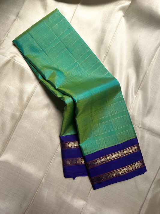 Madhurima – Handwoven Peacock Green Pure Kanchipuram Silk Saree with All-Over Zari Stripes, Contrasting Royal Ink Blue Rettapet Border & Matching Blouse Fabric (Silk Mark Certified)