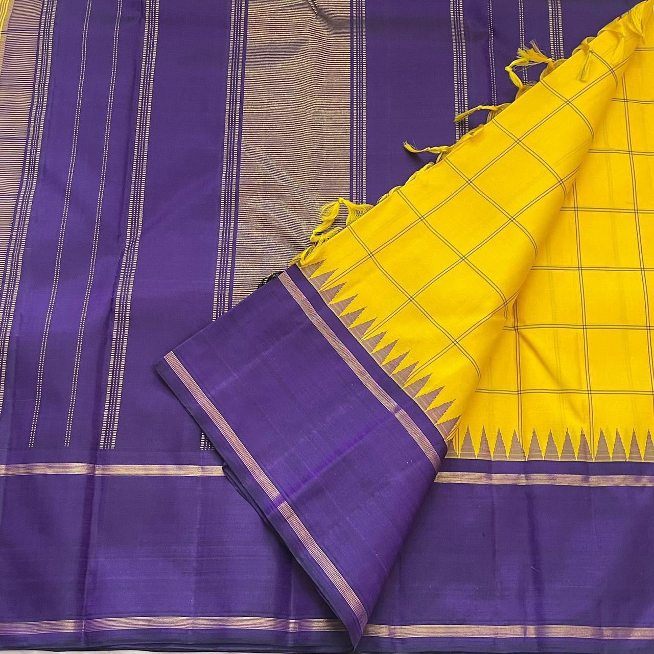 Haldi Violet Kattam Korvai
Pure Kanchipuram Silk Saree – Bright Haldi Yellow Checks with Contrasting Violet Korvai Borders
Minimal zari lines for an elegant look
Grand violet pallu with delicate zari stripes, silk mark certified, ships in 2 weeks