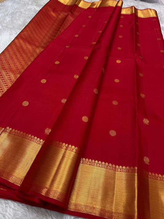 Handwoven Kanjeevaram silk saree featuring rich red silk body and classic gold zari border