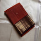 Kavi — oosi  kattam Pure Kanchipuram Silk Saree

Burnt Orange (saffron–rust) body
Deep coffee-maroon contrast border with grand antique-gold zari
Rich brocade pallu; peacock & floral vines in the border
Silk Mark Certified