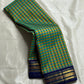 Mayil Pachai Kattam
Pure Kanchipuram Silk Saree – Peacock Green & Mustard Micro Checks
Royal blue korvai borders with gold floral zari detailing
Grand zari pallu with traditional zari weaving
Ships in two weeks free shipping, silk mark certified