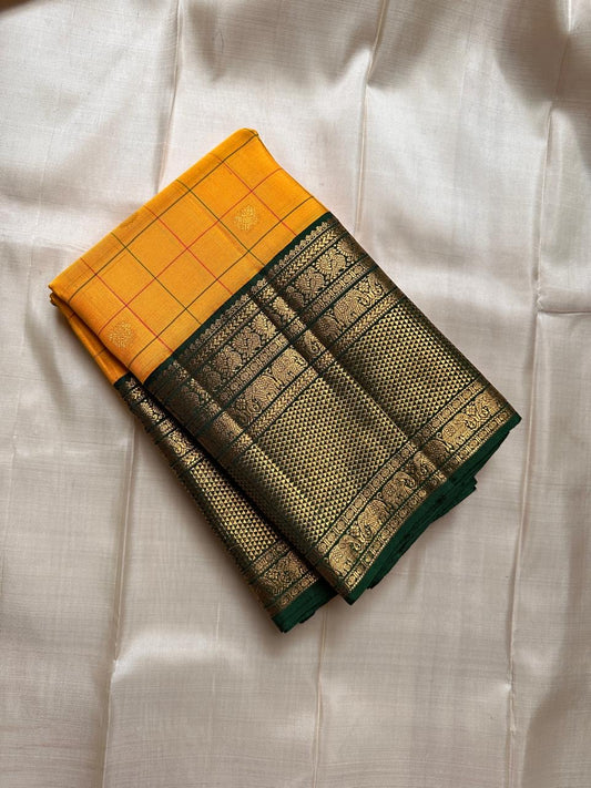 Manjal Pachai Kattam
Pure Kanchipuram Silk Saree – Marigold Yellow Body with Green Checks & Petite Zari Buttas
Deep Green Korvai Borders with Rich Gold Zari Weave & Traditional Elephant Motifs
Silk mark certified , ships in 2 weeks