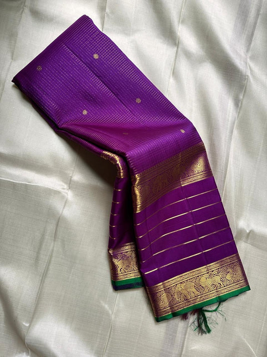 Kiran ✨ – Pure Kanchipuram Silk Saree
Regal Purple Body with Zari Kattam & Buttas
Classic Rettapet Border in Gold Zari Stripes
Intricate Heirloom-Inspired Zari Pallu
Accented with Contrast Green Selvedge Silk Mark Certified, delivery in 2 weeks