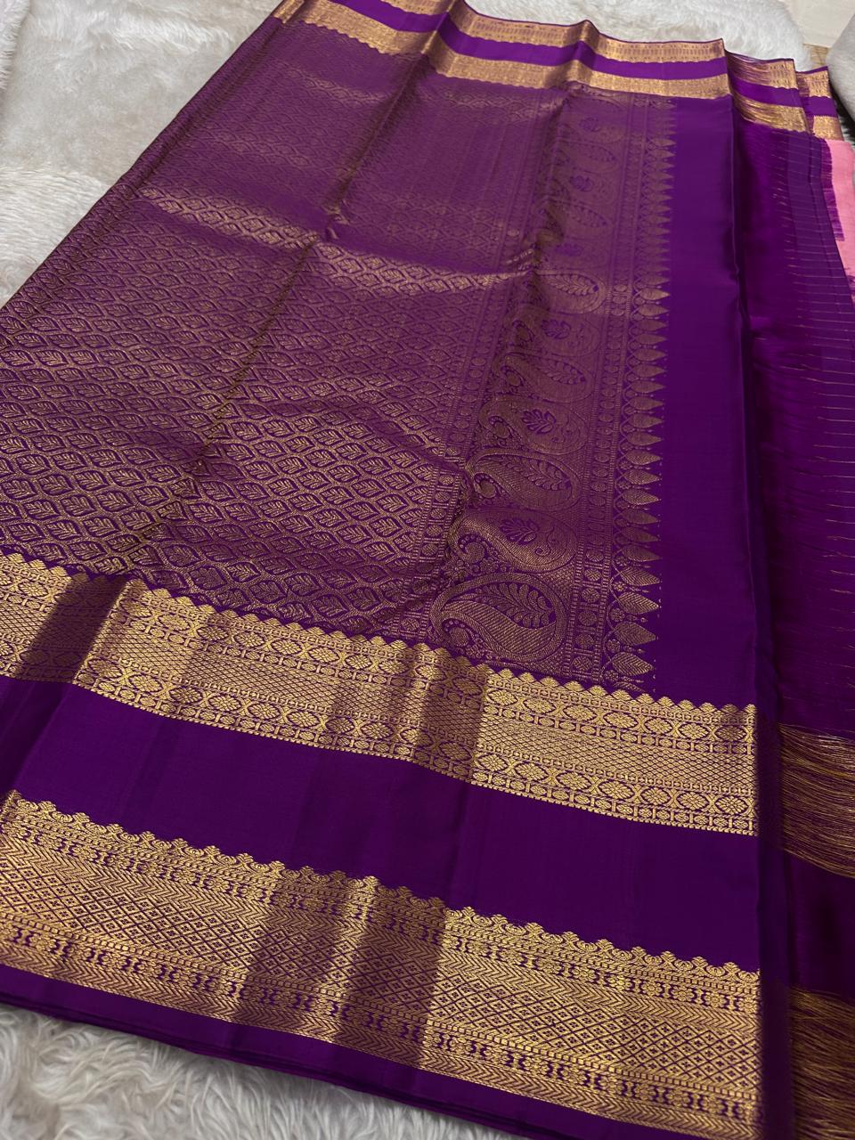 Blush Lattice – Pure Kanchipuram Silk Saree
Pleasant Pink Body with Zari Kattam Checks
Petite Kamalam Buttas Scattered Across the Body
Contrast Purple Rettapet Border with Ornate Motifs
Grand Purple Pallu. Silk Mark Certified, delivery in 2 weeks