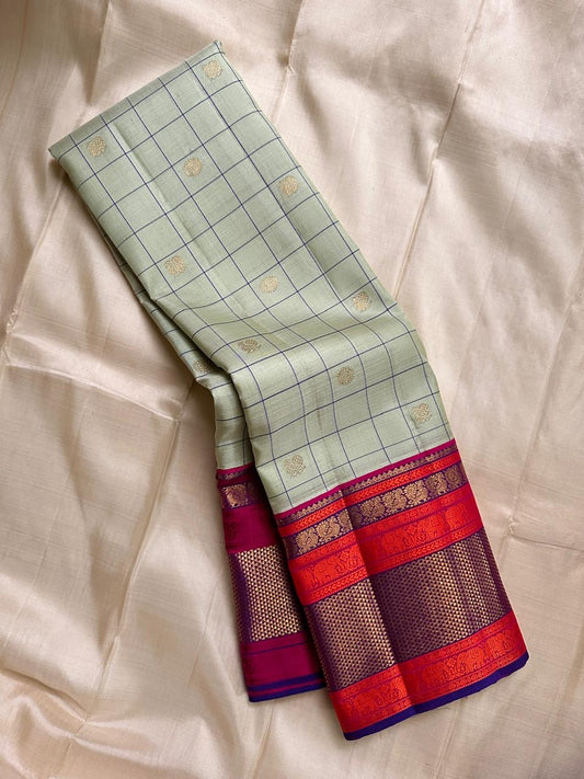 Pastel green pistachio with kungumam red and royal blue border dark blue silk thread checks mayil chakram butta magenta detailed Pallu