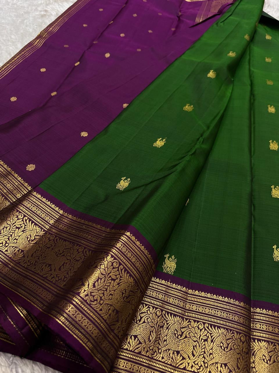 Emerald Plum Maankutti Butta — Pure Kanchipuram Silk Saree
Emerald green body with golden maankutti motifs and a plum korvai border woven in rich zari grandeur.
Silk Mark Certified • Free Shipping within USA • Ships in Two Weeks ✅