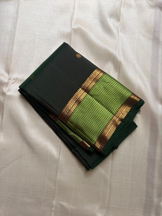 Pachai Maragatham — Pure Kanchipuram Silk Saree
Deep pachai (forest green) body with gold chakram buttas and maragatham chevron zari borders, finished with a coffee-brown brocade pallu.
Silk Mark Certified • Blouse Stitching Available ($30) • Free Shippin