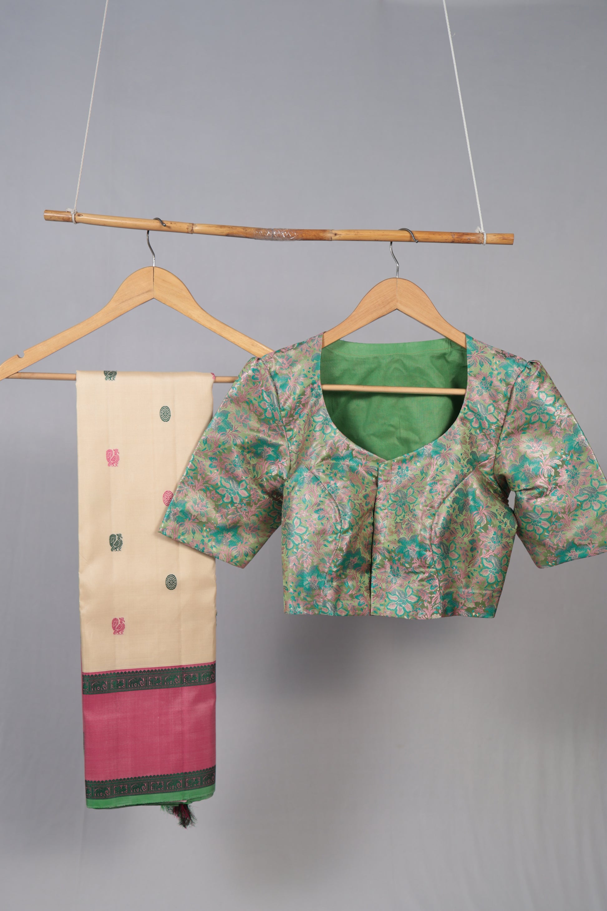 Close-up of ivory no-zari Kanchipuram silk saree body with pink and green woven silk-thread buttas