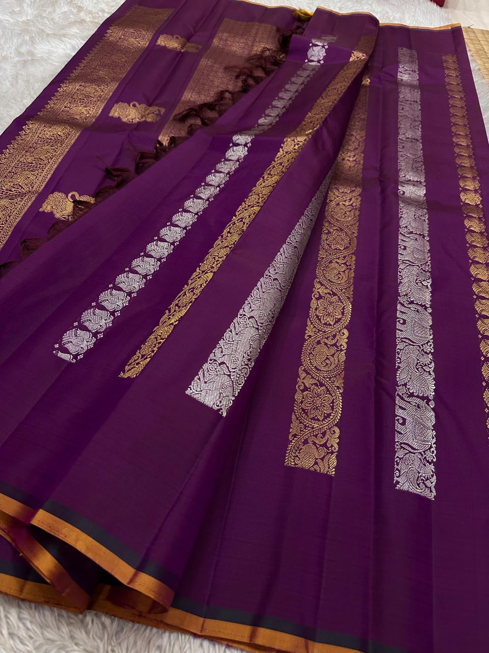 Lavanya– radiant purple Handwoven Kanchipuram Silk Saree in purple with Gold & Silver Zari, this deep purple Kanchipuram silk saree with intricate motifs in gold and silver zari, including Gandaberunda, parrots, elephants &lotuses as seen on Nita Ambani
