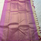 Magenta-lavender pallu laid out with allover gold zari woven design and cream tassels along the edge on a white sheet.
