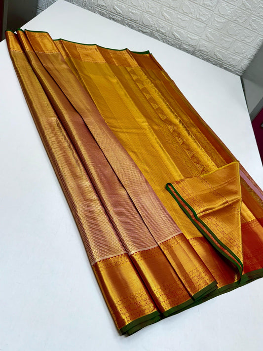 A resplendent blend of maroon rust & green, framed by rich gold zari borders. The pallu gleams with traditional thazhampoo motifs