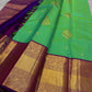 This pure silk Kanchipuram saree features a radiant shot color blend of green, gold, and blue, adorned with delicate zari buttas. A regal royal purple rettapet border and an elaborate peacock motif pallu complete this timeless drape — perfect for festive