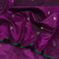 Draped in deep violet and plum, this pure silk Chanderi saree glows with a gentle sheen and graceful vertical zari lines. Delicate diamond meenakari motifs and finely woven borders lend a touch of tradition, with a  contrast green selvedge