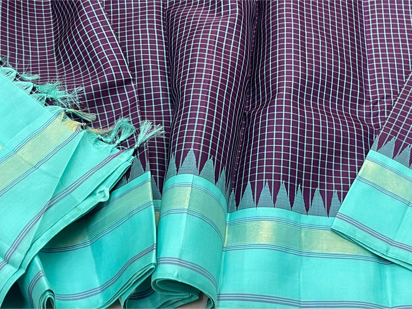 Pure Handwoven Kanchipuram Silk Saree – Deep Aubergine Body with Micro Checks
Contrasting Aqua Blue Korvai Borders with Temple Motifs & silk thread  Stripes
Elegant Striped Aqua seer Pallu
Silk Mark Certified ✅ ships in 2 weeks.