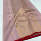Folded Dusty Rose Chanderi saree showing the gold buttas and red contrast border
