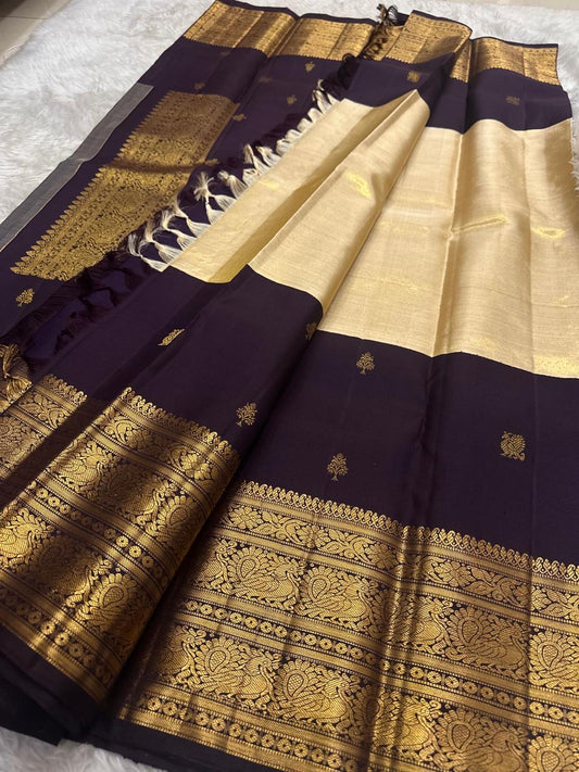 Handwoven Kanjeevaram silk saree featuring deep purple body and luminous champagne gold pallu