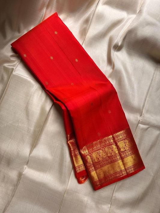 Fiery orange red shot double  color small flower motif with vanasringaram and Rudhraksham border pure silk mark certified Kanchipuram saree