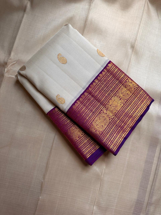 Hamsa Paisley — Pure Handloom Kanchipuram Silk Saree 
Ivory Body with Gold Paisley Buttas & Royal Purple Brocade Border ✨
Silk Mark Certified • free shipping within Usa ships in two weeks