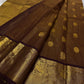 Front view of deep rustic brown with a soft petal pink pallu Kanchipuram silk saree with small zari border and rich pallu.