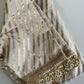 Banarasi soft silk blouse in leheriya pattern with hand embroidered sleeves in cream and gold