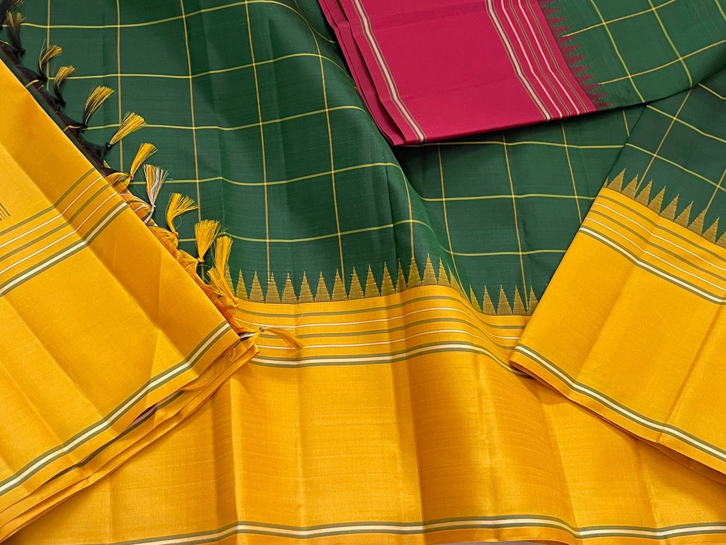 Vasantha Oli Kattam — Pure Silk Kanchipuram
Radiant mustard-yellow body with parrot-green kattam checks 🌿
Temple korvai borders & raspberry-pink contrast pallu ✨
Lightweight festive handloom weave with gold zari accents 💫
Silk Mark Certified • Free Ship