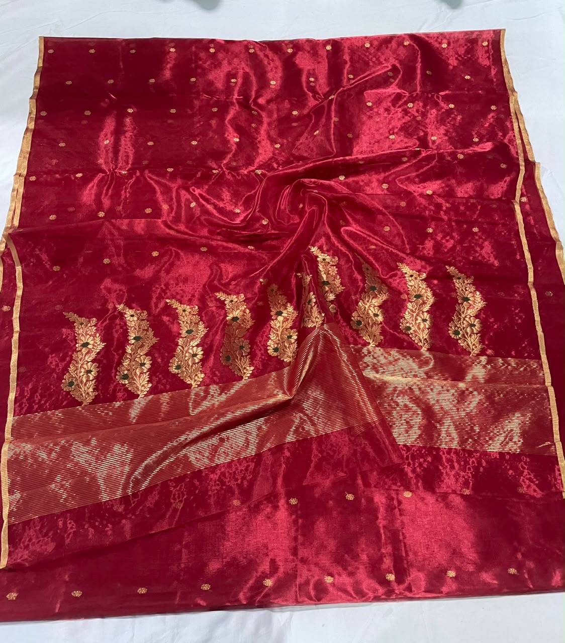 Folded Crimson Red handloom Chanderi saree with antique-gold floral buttas and narrow gold edging