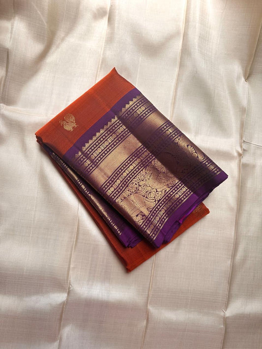 Pure silk kanchipuram serene terracotta  orange with purple border  mayil and kamalam butta on body and Pallu