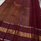 Pankajam 🌺 – Brown maroon Kanchipuram Silk Saree with Zari Kattam, Dashed Lines, Kolam Motifs, Varisaipet Border with Thandavalam Zari Stripes, Rudrakshpet, Annam & Kamalam Motifs, Deep Brown Selvedge & Ornate Pallu