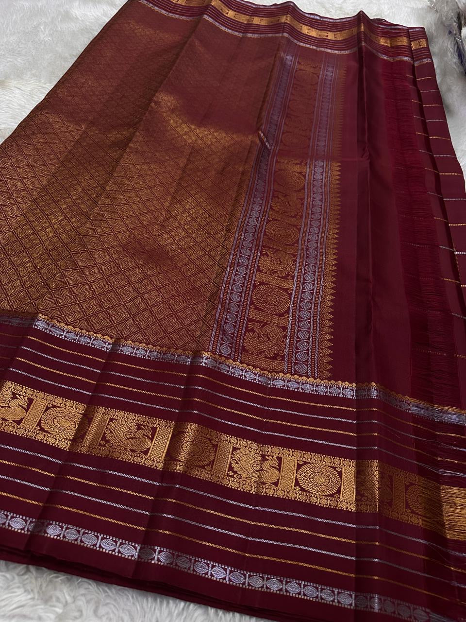 Pankajam 🌺 – Brown maroon Kanchipuram Silk Saree with Zari Kattam, Dashed Lines, Kolam Motifs, Varisaipet Border with Thandavalam Zari Stripes, Rudrakshpet, Annam & Kamalam Motifs, Deep Brown Selvedge & Ornate Pallu