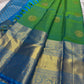Parrot green Kanchipuram silk saree with gold zari coin buttas, contrast sky blue zari border and pallu