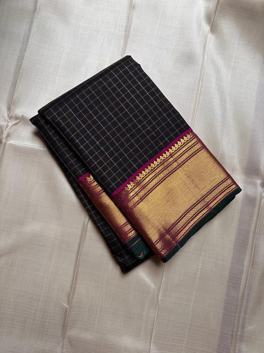 Charcoal Zari Kattam – Pure Kanchipuram Silk Saree
Rich Charcoal Black Body with Gold Zari Checks
Broad Golden Border with Magenta Highlights & Green Selvedge
Royal Magenta Pallu with Lustrous Zari Stripes

Silk Mark Certified, delivery in 2 weeks