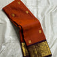 Rust Orange & Wine Korvai – Pure Kanchipuram Silk Saree
Burnt rust-orange shot body with dainty gold paisley buttas
Deep wine korvai borders in antique gold—Annapakshi & Yaali medallions
Grand wine pallu with full-zari jaal & temple panels
Silk Mark