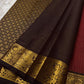Mantra – Ruby Red coffee brown Kanchipuram Silk Saree with zari Checks with small buttas all over and Antique Peacock zari Border  showcasing regal peacocks and floral vines. A richly detailed pallu completes this heritage Zari kattam