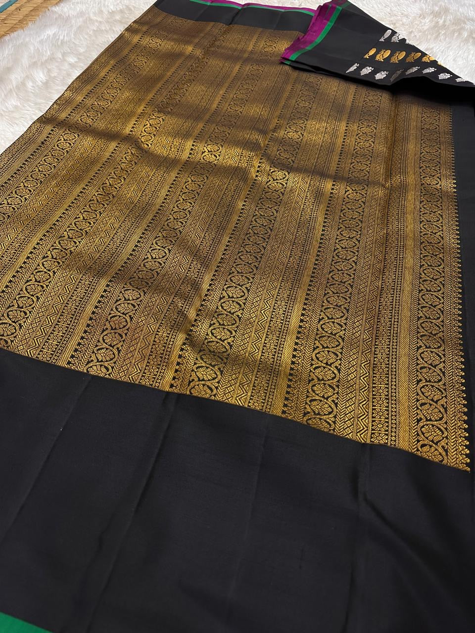 Lavanya – Black Handwoven Kanchipuram Silk Saree with Gold & Silver Zari

A timeless black Kanchipuram silk saree with intricate gold and silver zari motifs — Gandaberunda, parrots, elephants, and lotuses — exuding regal elegance.