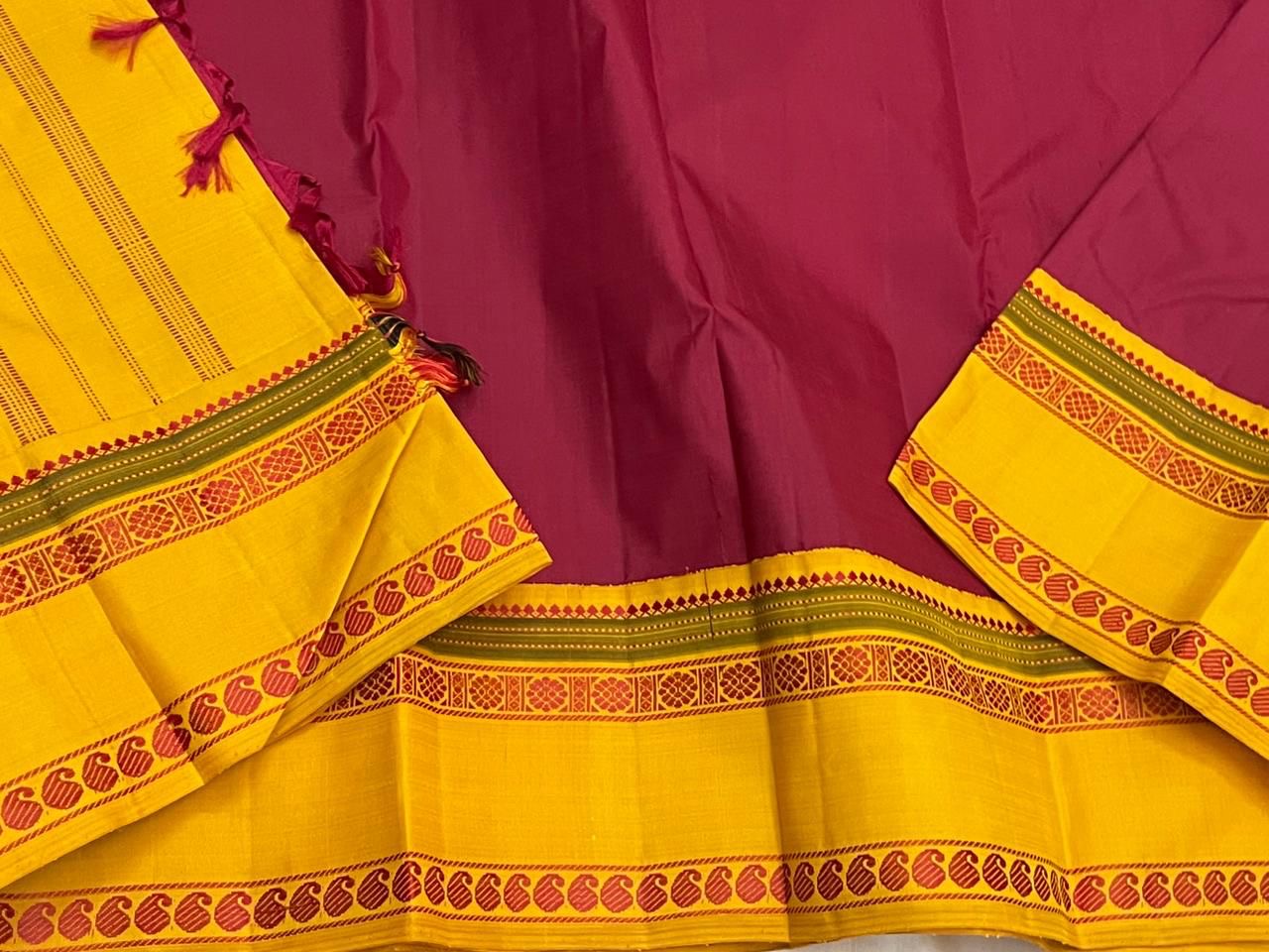 Turmeric Saffron Rettapettu — Pure Kanchipuram Silk
Rani pink body with saffron-yellow twin rettapettu borders & temple thread motifs
Silk Mark Certified • Free Shipping within USA • Ships in Two Weeks