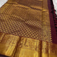 A majestic maroon Kanchipuram silk saree, adorned with intricate golden zari featuring the mythicalYazhi (Yali ) motifs—a symbol of divine strength and protection in Hindu mythology. The grand temple-style gold border adds depth and regality, making this