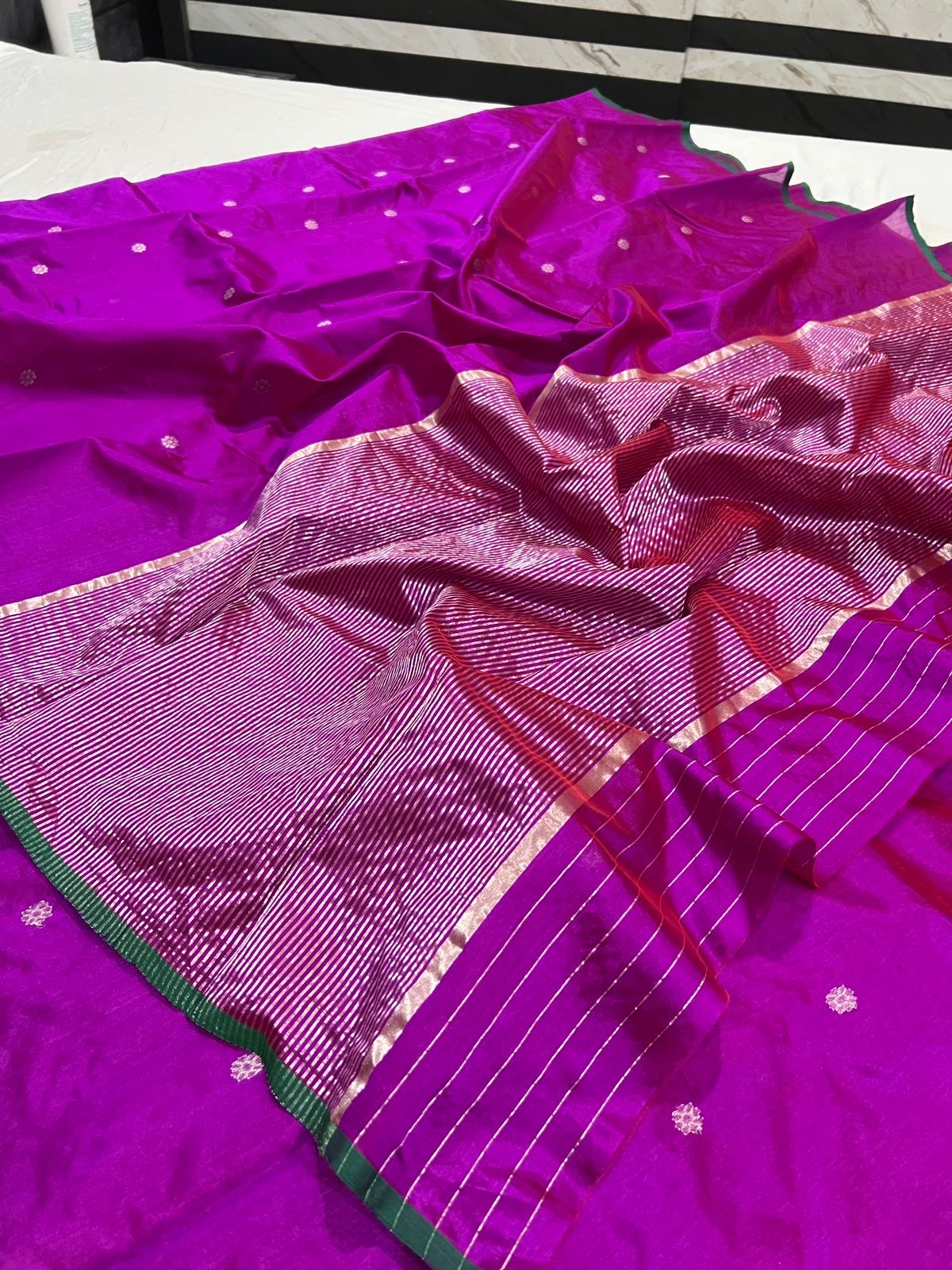 Close view of magenta handloom Chanderi silk with metallic buttas and finely striped woven pallu